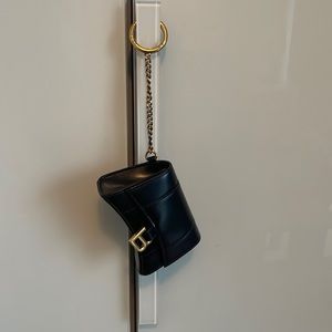 Black leather with a golden chain Balenciaga keychain holder. Side pocket